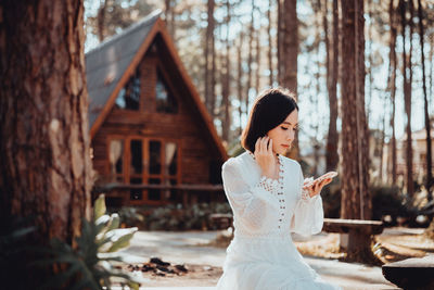 Woman standing on mobile phone