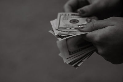 Cropped hand holding paper currency