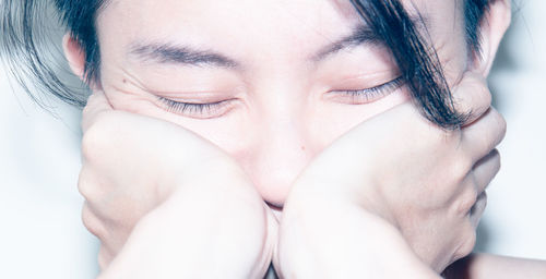 Close-up portrait of young woman with eyes closed