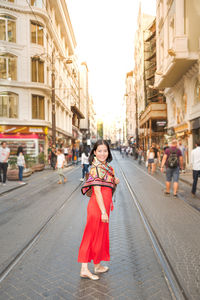 Portrait of smiling woman in city street