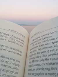 Close-up of open book against sky