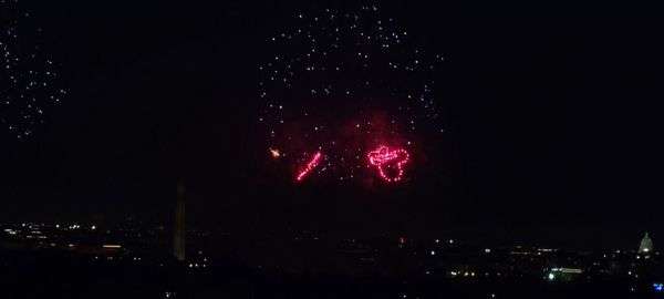 Low angle view of firework display at night