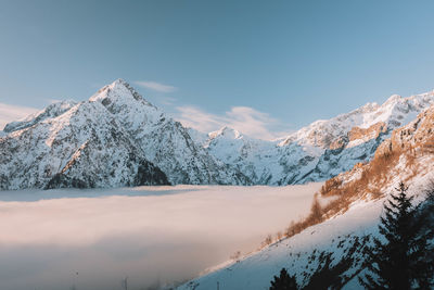 Scenic view of snowcapped mountains against clear sky