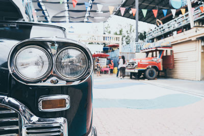 Close-up of cars on street in city