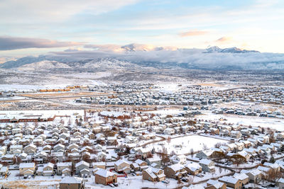 High angle view of snow covered buildings against sky