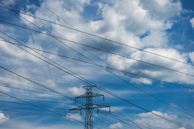 Low angle view of electricity pylon against sky