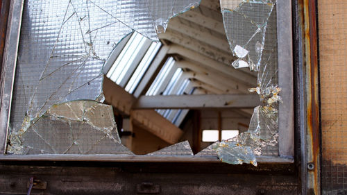 Low angle view of broken glass window