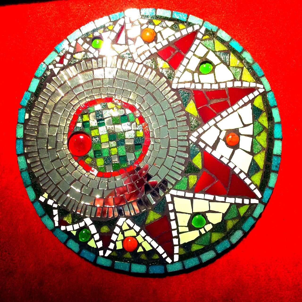 circle, red, art and craft, multi colored, art, creativity, human representation, indoors, geometric shape, animal representation, wall - building feature, shape, round, cultures, no people, pattern, day, built structure, celebration