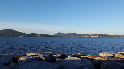 Scenic view of sea against clear blue sky