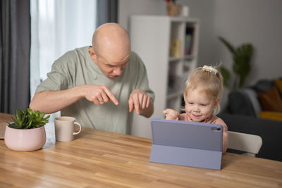 Side view of boy using laptop at home