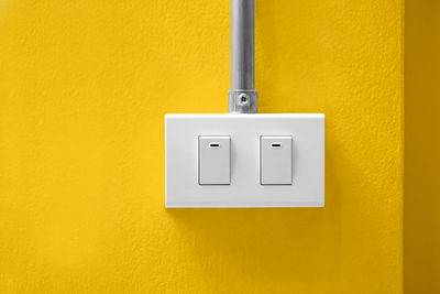 Close-up of electric switch on wall