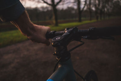 Midsection of man with bicycle on street