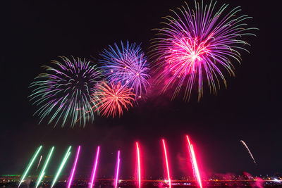 Low angle view of firework display at night