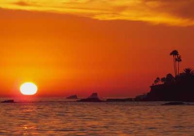 Scenic view of sea against romantic sky at sunset