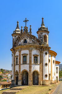 Low angle view of building against clear blue sky