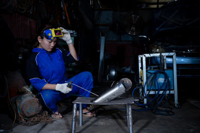 Rear view of man working in factory