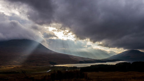 Scenic view of mountains against cloudy sky