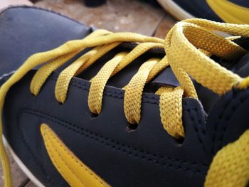 Close-up high angle view of yellow shoelace
