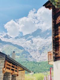 Houses by mountains against sky in city