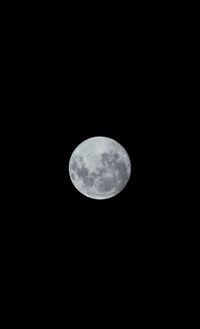 Low angle view of moon against sky at night