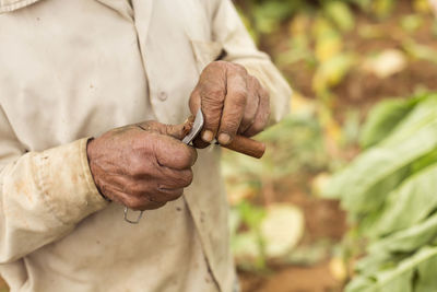 Close-up of hand holding ice cream standing outdoors