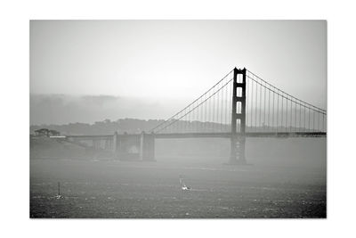 View of suspension bridge against clear sky