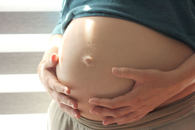 Close-up of woman touching head