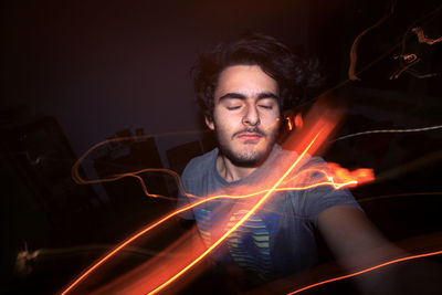Close-up of young man with light painting
