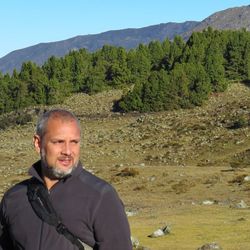 Portrait of smiling man on mountain against sky