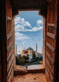 Buildings against sky seen through arch window. hagia sofia - ayasofya 