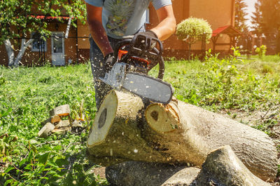 Man holding umbrella in yard