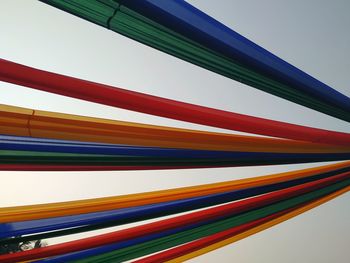Low angle view of multi colored pencils against sky