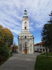 Church by building against sky