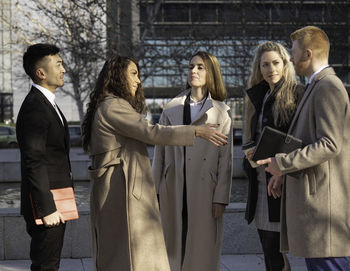 Portrait of smiling couple standing in city