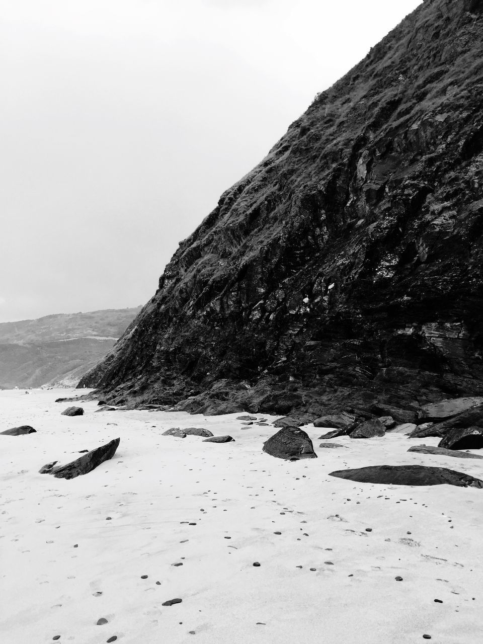 beach, tranquil scene, tranquility, water, sand, clear sky, scenics, shore, beauty in nature, nature, sea, mountain, copy space, sky, idyllic, non-urban scene, coastline, remote, day, outdoors