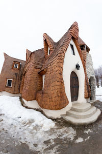 Snow covered built structure against sky