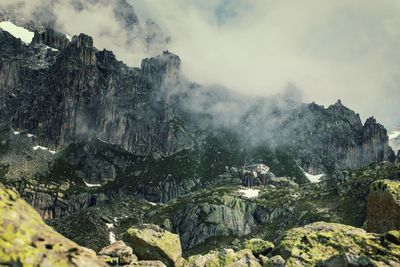 Aerial view of mountain range against cloudy sky