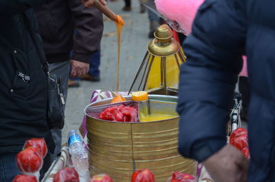 Midsection of people at market stall in city