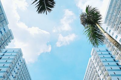 Low angle view of modern building against cloudy sky