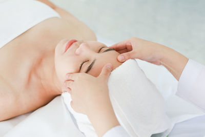 Midsection of woman lying on bed