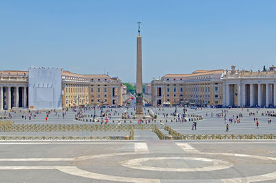 Buildings in city against clear blue sky