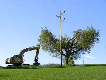 Traditional windmill on field against clear sky