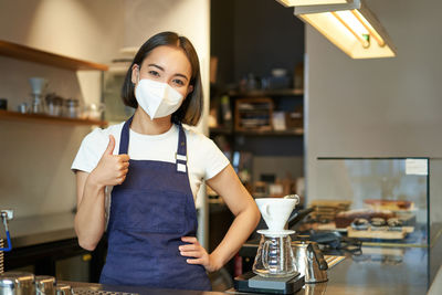 Portrait of young woman drinking coffee