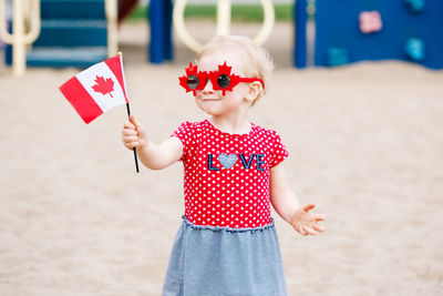 Midsection of girl holding umbrella