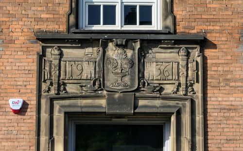 Stone carving above entrance of holyrood secondary school.