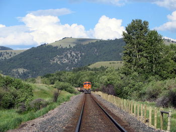 Railroad track against cloudy sky