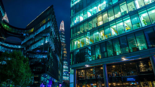 Low angle view of illuminated modern buildings and shard london bridge