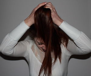 Portrait of woman pulling hair out
