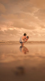 Man photographing at sunset