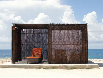 Built structure on beach against sky